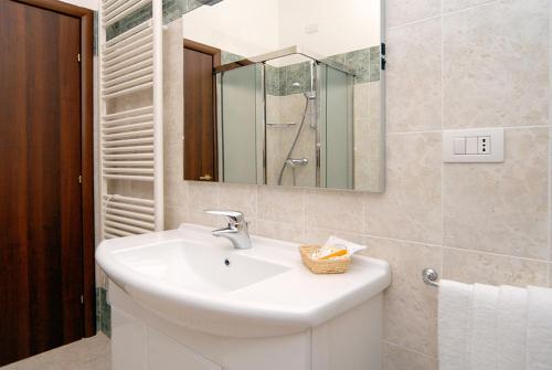 a bathroom with a sink and a mirror at Hotel La Chiesaccia in Crespellano
