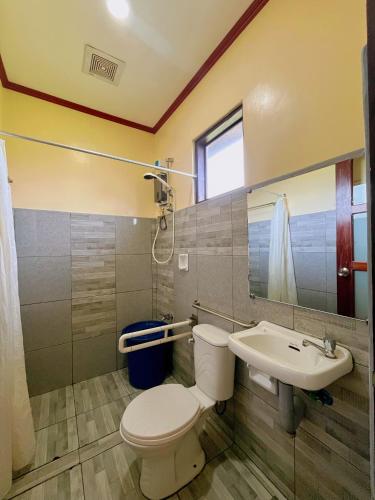 a bathroom with a toilet and a sink at Marianne's Guest House in New Agutaya