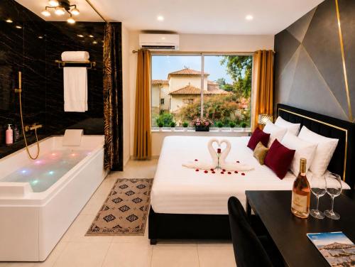 a bedroom with a tub and a bed with a swan on it at Luxury Beach Room in Frontignan