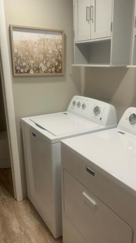 a white washer and dryer in a kitchen at Trailside Lake Retreat in Gaylord