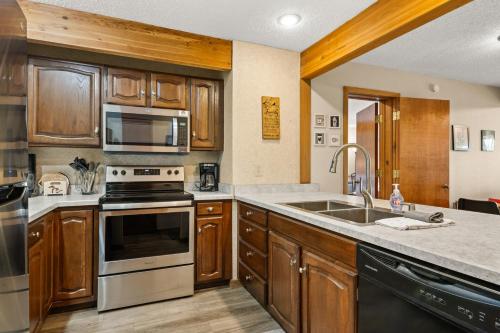 a kitchen with a sink and a stove top oven at Timber Ridge Retreat in Bellaire