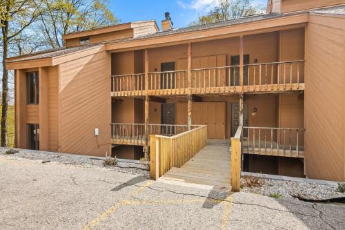 an apartment building with a balcony and a porch at Timber Ridge Retreat in Bellaire