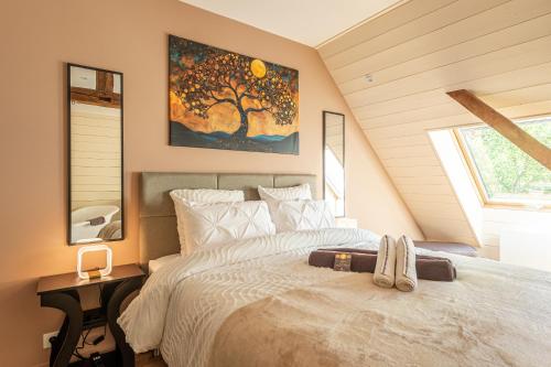 a bedroom with a bed and a tree painting on the wall at Le Moulin de mes garçons in Alby
