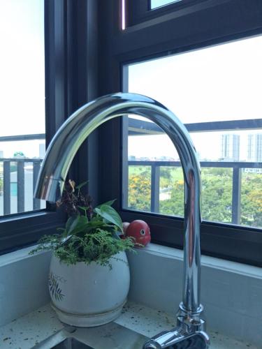 a kitchen sink with a faucet next to a window at Homestay Vân Canh Hà Nội in Ðại Tự