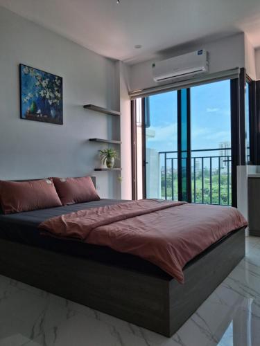 a bedroom with a large bed with a large window at Homestay Vân Canh Hà Nội in Ðại Tự