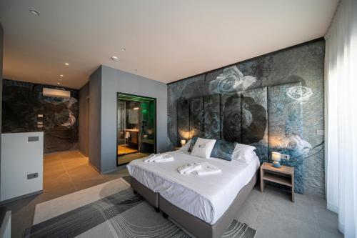 a bedroom with a large bed with a painting on the wall at Residence Diana Seafront in Bibione