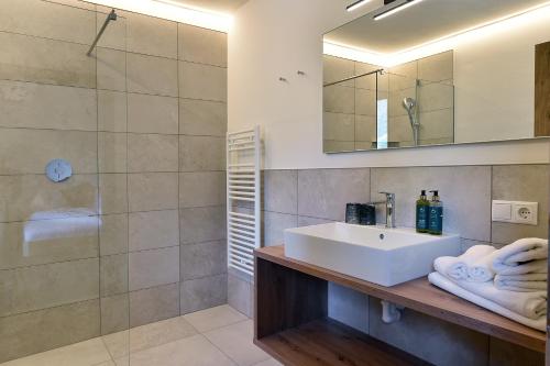 a bathroom with a sink and a shower at Chalet Anna in Marlengo