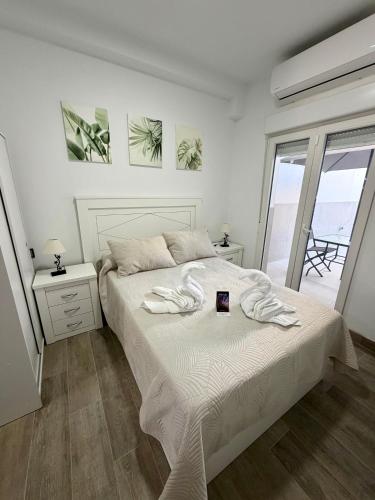 a bedroom with a bed with two towels on it at Apartamento Martina 2 in Mérida