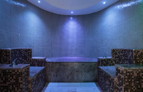a large bathroom with a tub with blue lights at Arty Grand Hotel in Olympia
