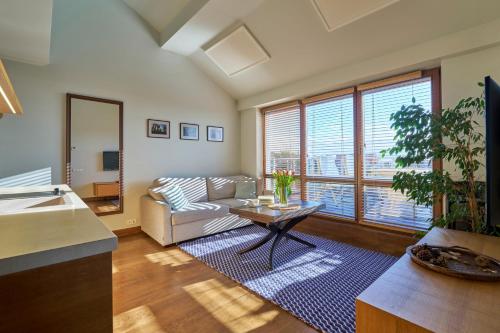 a living room with a couch and a table at Visit Nida Apartments in Nida