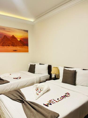 two beds in a hotel room with candy canes on them at Marquis Pyramids Hotel in Cairo