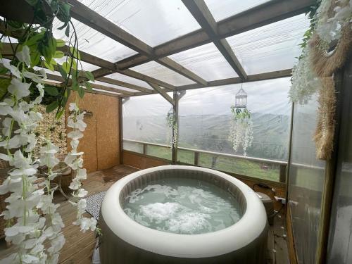 a bath tub in a room with a window at Refúgios do Rio Dão in Mangualde