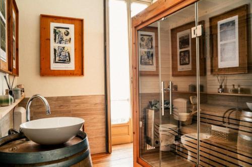 a bathroom with a sink and a glass shower at Villa Guelpa in Lessona