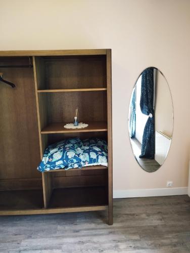 a bedroom with a bed and a mirror at Chez Nanard et Lili in Bec-de-Mortagne