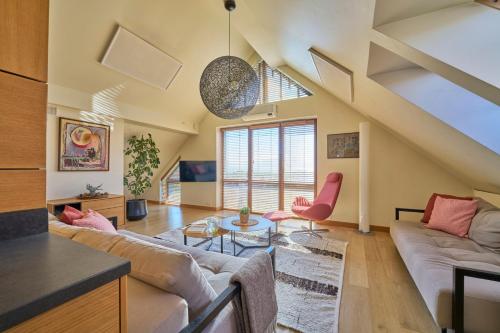 a living room with a couch and a table at Visit Nida Apartments in Nida