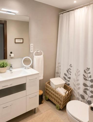 a bathroom with a sink and a toilet and a mirror at MARSOL RELAX Roda de Barà in Roda de Bará