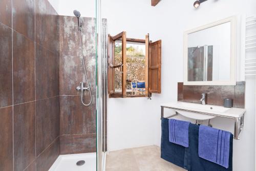 a bathroom with a shower and a sink at Darrera Es Campanar in Bunyola