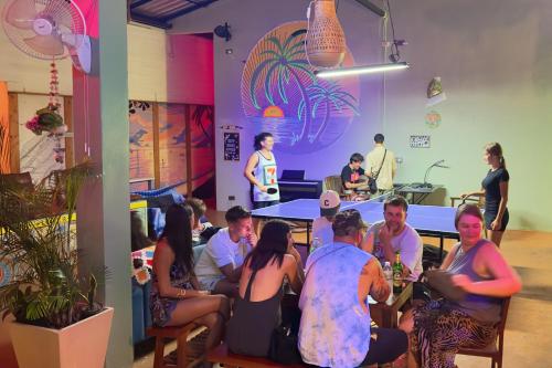 a group of people sitting around a table in a room at Beach Jungle in Ko Chang