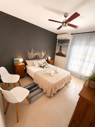 a bedroom with a bed and a ceiling fan at MARSOL RELAX Roda de Barà in Roda de Bará