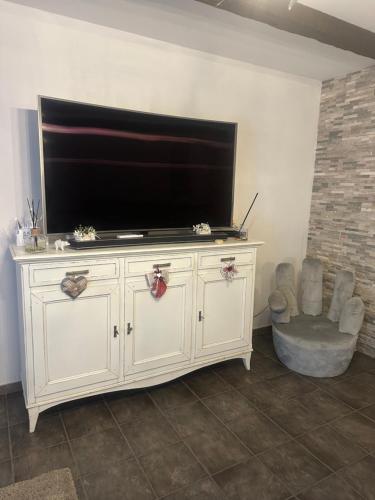 a large white entertainment center with a flat screen tv at Aer in Caserta