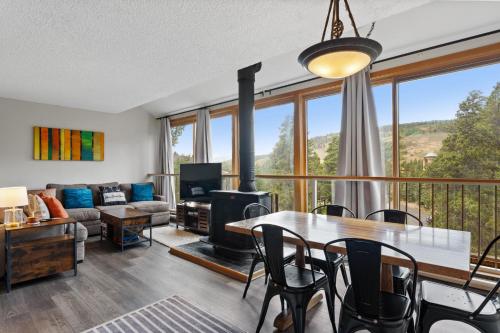 a living room with a table and chairs and a fireplace at Decatur #1797 in Keystone