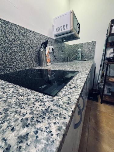 a black cat sitting on a kitchen counter at MK VALeNCIA in Valencia