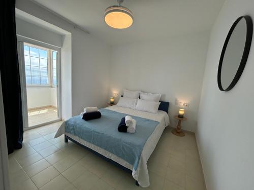 a bedroom with a bed and a large window at Villa La Gavina Sea View Pool and Beaches in Blanes
