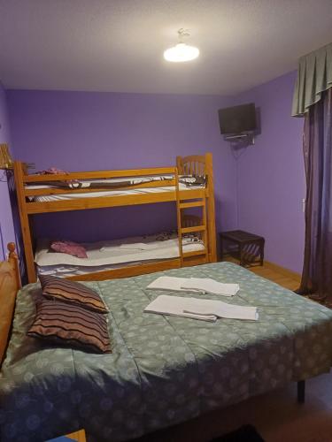 a bedroom with a bunk bed with a blue wall at Hostal Amanecer in Fuentebureba