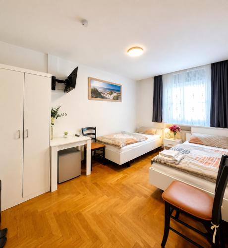 a living room with two beds and a desk at Stendaler Apartments in Stendal