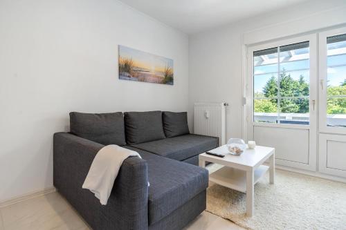 a living room with a couch and a table at Feriendomizil Putbus - Nr. 3b in Putbus