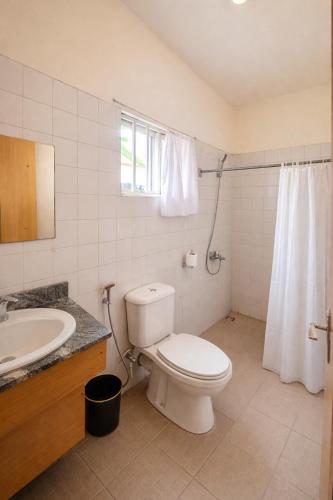 a bathroom with a toilet and a sink at Royalbirds Motel in Akure