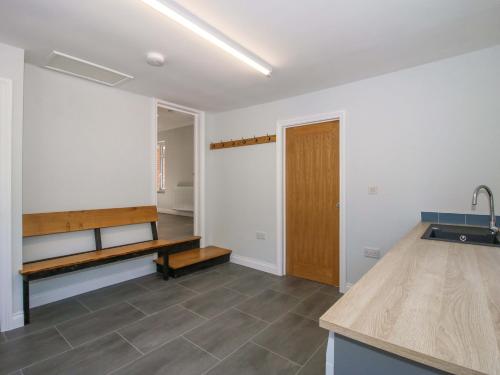 a kitchen with a counter and a bench in a room at Westington Hall in Leominster