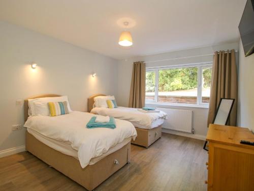 a bedroom with two beds and a window at Westington Hall in Leominster