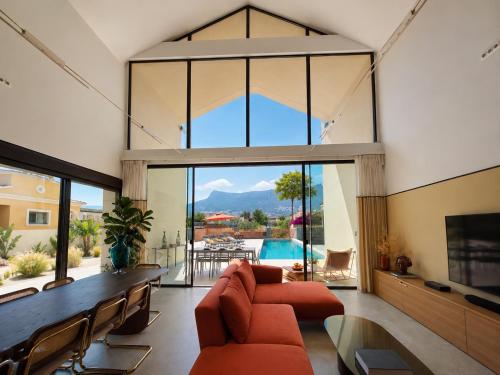 a living room with a couch and a large window at Luxury Villa Galaxy Beach 12min walk 15m pool in Calpe