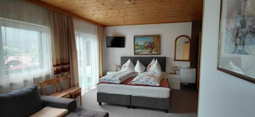 a bedroom with a bed with pillows on it at Pension Brunner in Bad Kleinkirchheim