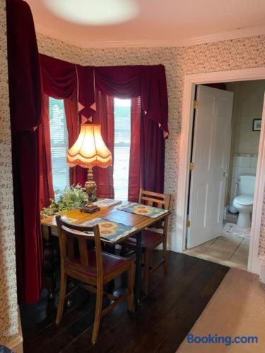 a dining room with a table with chairs and a lamp at Hillcrest Bed and Breakfast in Jim Thorpe