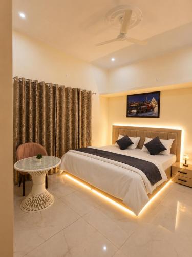 a bedroom with a bed and a table in a room at Sukoon stays Bhimtal 3 bed in Bhīm Tāl