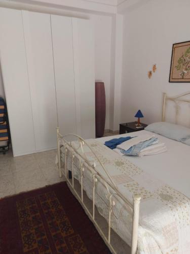 a bedroom with a white bed and a table at Mare Blu' in Crotone