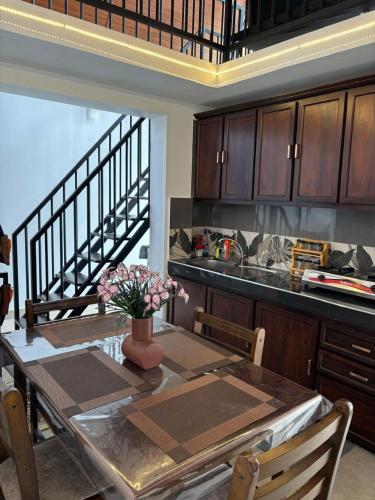 a kitchen with a dining room table and a staircase at Annfield Cabana in Hatton