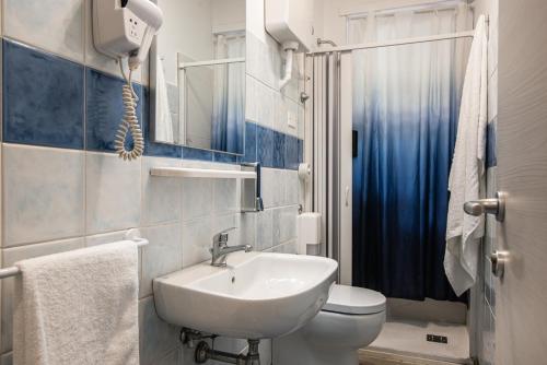 a bathroom with a white sink and a toilet at Aulino House in Catania