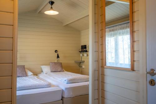 a small room with two beds in a house at Efri-Vík Bungalows in Kirkjubæjarklaustur