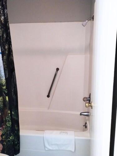 a bathroom with a bath tub with a towel at Gateway Inn in Lake City