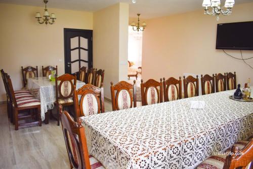 a dining room with a table and chairs at Pensiunea Baias in Bîrsana