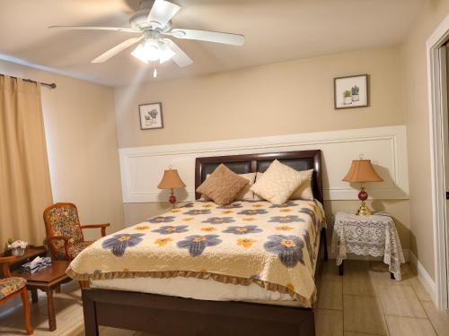 a bedroom with a bed and a ceiling fan at Near Cavendish Beach-1 in Stanley Bridge