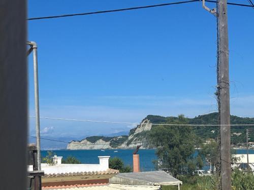 a view of the ocean from a house at Happiness Apartment 7 in Sidari