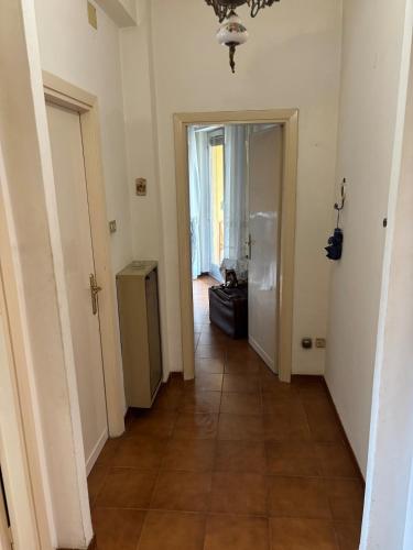 a hallway with two doors and a tile floor at Spacious Apartment 20min from Piazza Maggiore in Bologna