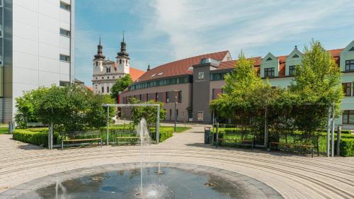a fountain in a courtyard in front of a building at Holiday Inn Trnava by IHG in Trnava