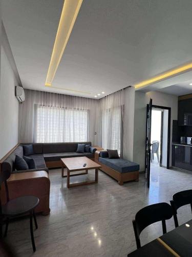 a living room with a couch and a table at Résidence saint germain in Kelibia