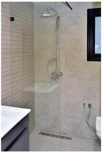 a shower with a glass door in a bathroom at Résidence saint germain in Kelibia