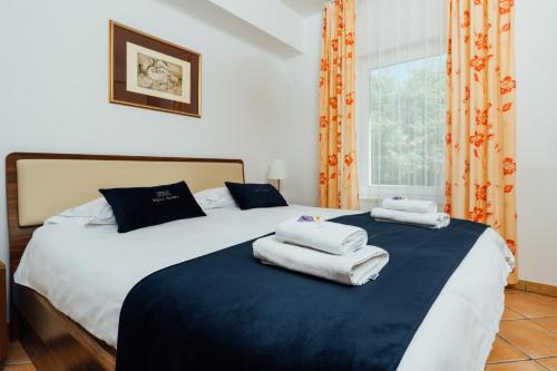 a bedroom with two beds with towels on them at Villa Almira in Izola